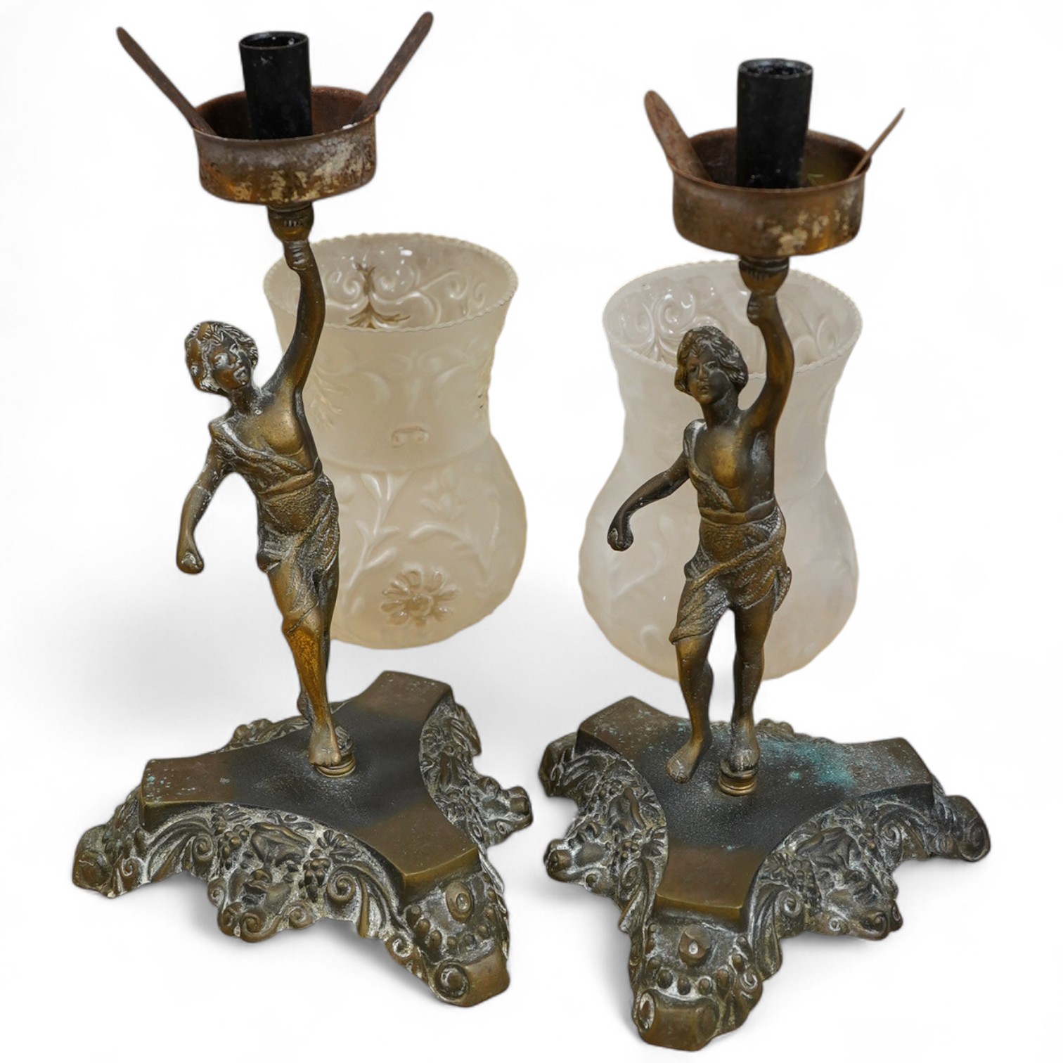 A pair of brass figural lamps with frosted glass shades, 47cm high